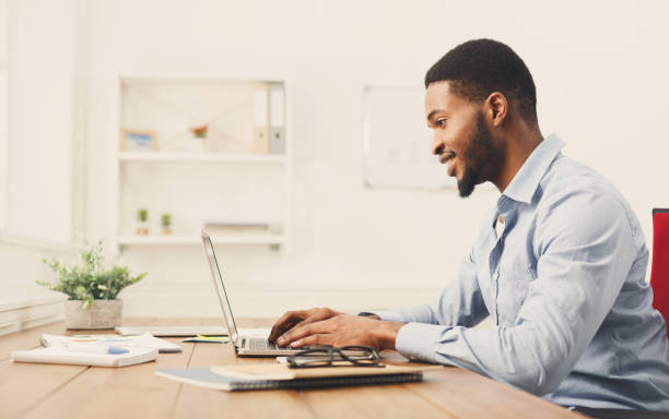 istock Young black businessman working with laptop 896815364