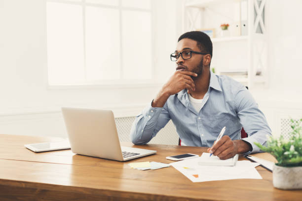 istock Young black businessman working with laptop 896819616