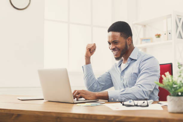 istock Happy businessman win. Winner, black man in office 896819654