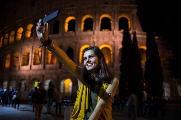 istock Smiling tourist taking night selfie in Italy 896819892