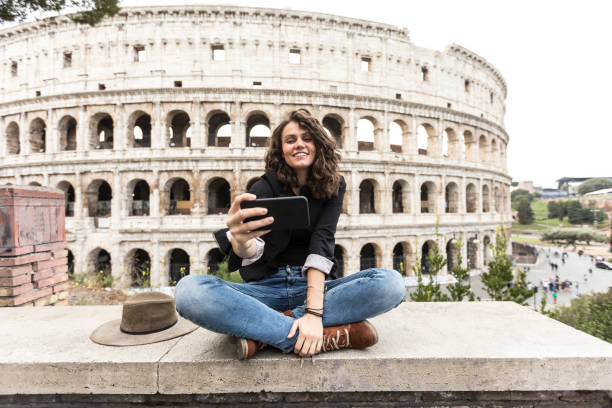 istock Young woman taking selfie in front of Coliseum 896819928