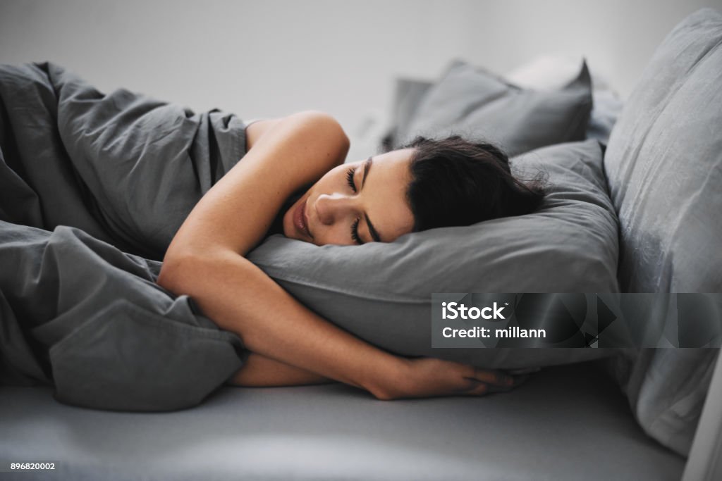 Girl sleeping Girl lying down in bed and sleeping Sleeping Stock Photo
