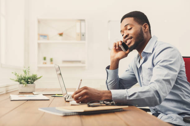 istock Young black businessman talking on mobile phone 896820054