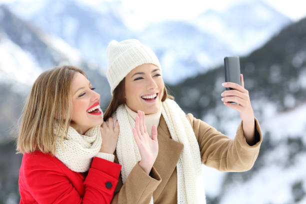 istock Two tourists having a video call in winter holidays 896820356