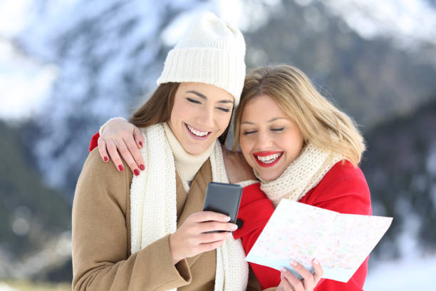 istock Two happy tourists searching on line in winter holidays 896822414