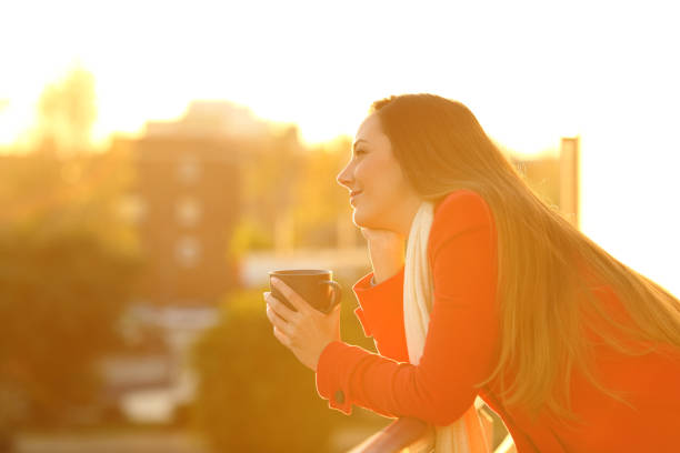 istock Dreamer dreaming in a balcony in winter 896822740