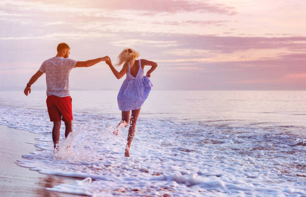 istock Happy couple at romantic sea sunset 896823342