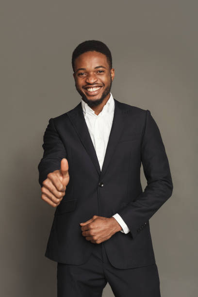 istock Happy black man showing thumb up gesture, studio shot 896827896