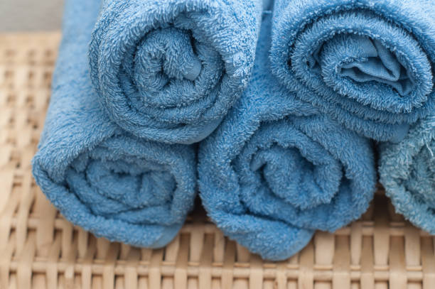 istock blue rolled bath towels on wooden trunk in bathroom 896831962