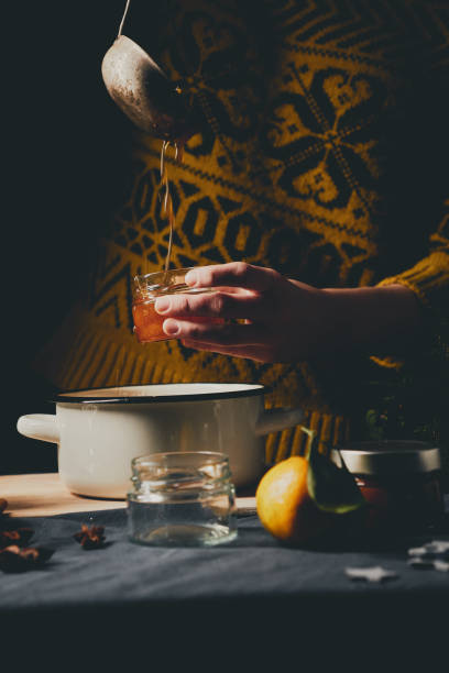 istock Pouring homemade orange jam into jars 896836732