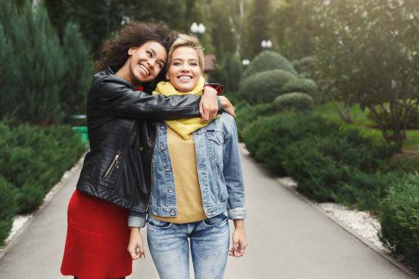 istock Happy girls having fun while walking in the park 896837558