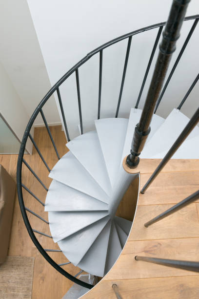 istock Wide angle of living space and kitchen with spiral staircase. 896845902