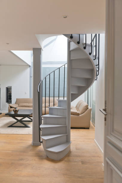 istock Wide angle of living space and kitchen with spiral staircase. 896845946