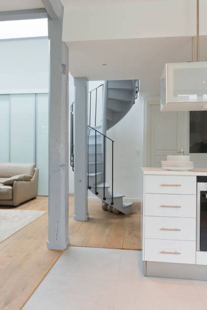 istock Wide angle of living space and kitchen with spiral staircase. 896846094