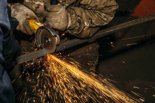 istock Worker cutting metal with blade in factory 896858050