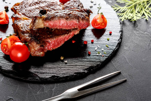 istock Rare rib eye steak on dark plate, closeup 896864946
