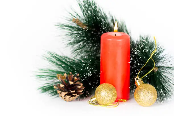 red candle and xmas tree decorations, christmas composition isolated on white