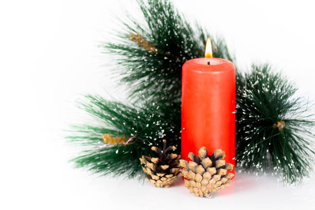 istock red candle and pine tree branch, christmas composition isolated on white 896881316