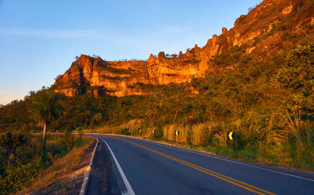 Beautiful road to the city of Chapada dos Guimarães with mountain of stones in the background in sunset. stock photo