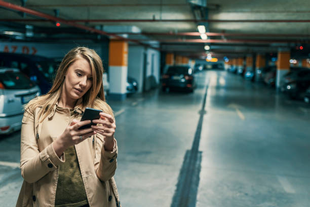 istock Woman Texting in the subway parking lot 896886744