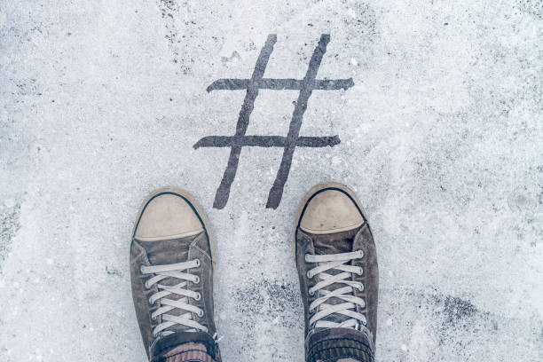istock Feet standing over hashtag imprint on street 896886870