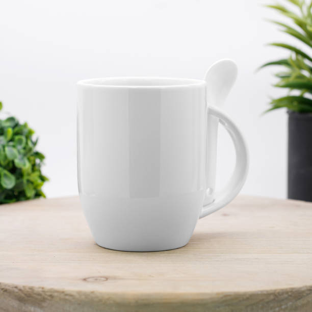 istock White coffee mug and spoon on backdrops. Ceramic tea cup for your design. 896902414