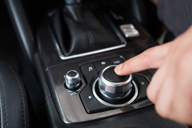 istock man pushes a button in the car, Modern car interior 896902790