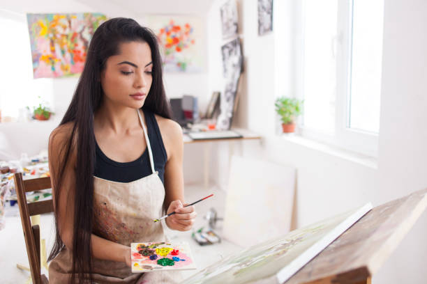 istock Beautiful young artist drawing in atelier 896906288
