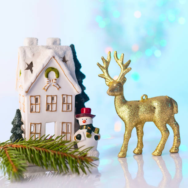 istock Christmas house and reindeer with bokeh lights 896909408