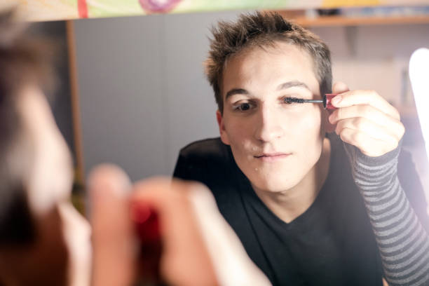 istock Young Adult Man Applying Mascara on his Eyelashes 896913442