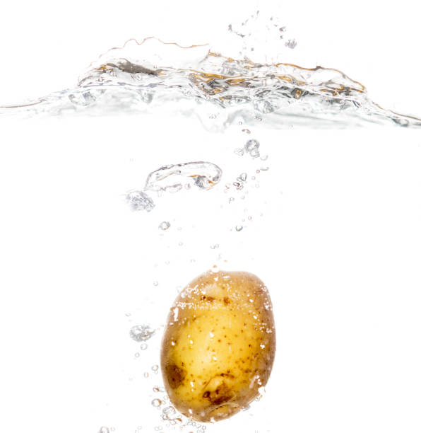 istock potatoes in water isolated on white background 896922372