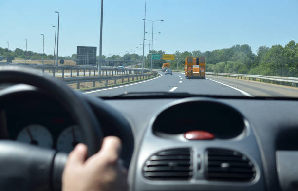 istock Man driving a car on a motorway 896922398