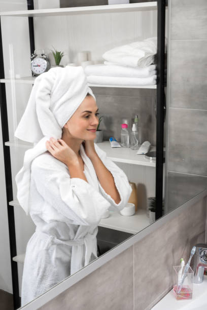 istock Smiling woman standing in bathroom 896930044
