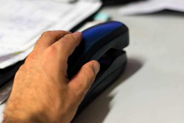 A hand and a phone, in an office