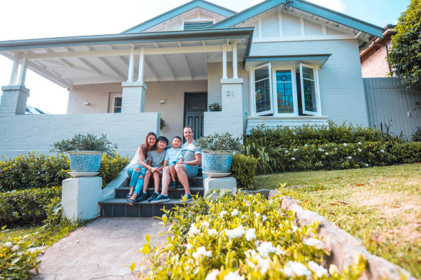 istock Sitting in front of their home 896949168