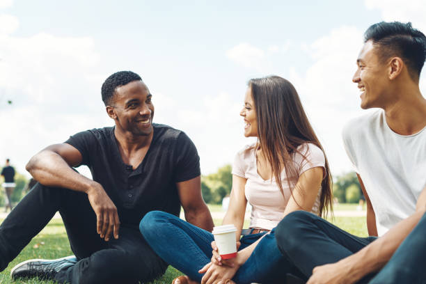Diverse group of people enjoying summer in public park