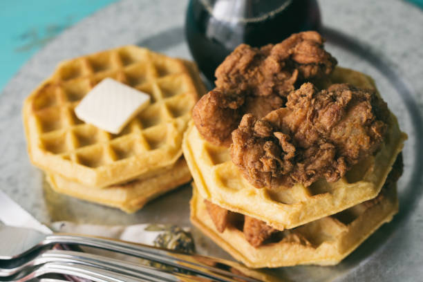 istock Fried chicken and waffles resting on a rustic turquoise blue table. 896967758