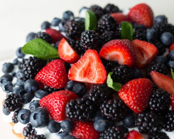 istock Mixed berry torte made with strawberries, blueberries and blackberries garnished with fresh mint. 896970622