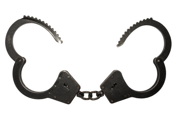 istock black metal handcuffs with small scratches on white background 896973368