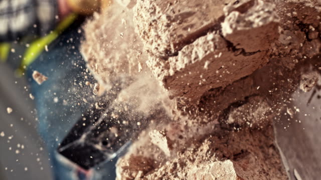 SLO MO Sledge hammer striking a brick wall