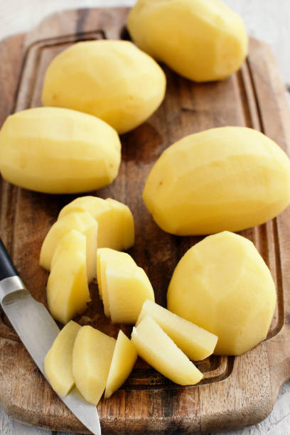 istock Raw peeled potatoes with a knife 896979220