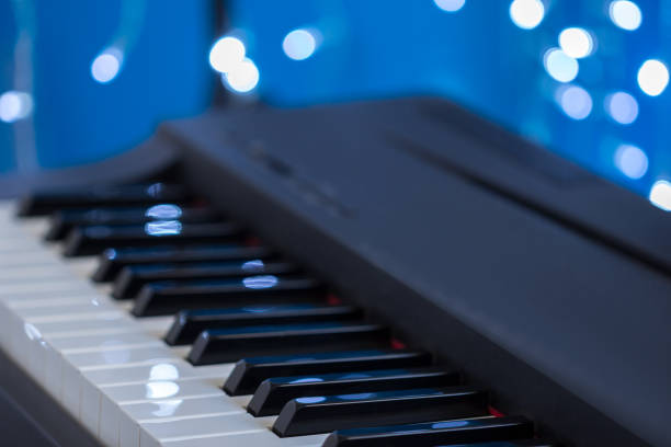 istock Piano keys side view on a blue bokeh background 896979564