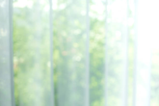 istock Blur of white curtain with window view / tree garden 896984272