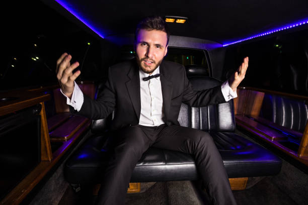 excited man in tuxedo in the back of a limo - high society men tuxedo party imagens e fotografias de stock