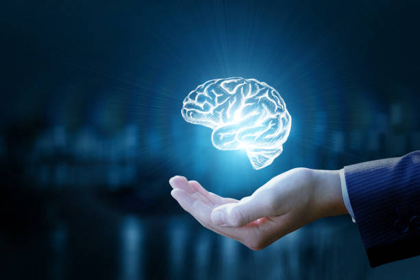 istock Businessman showing a brain on blurred background. 896987254