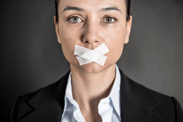 geschäftsfrau mit klebeband den mund zu - silence secrecy human mouth censorship stock-fotos und bilder