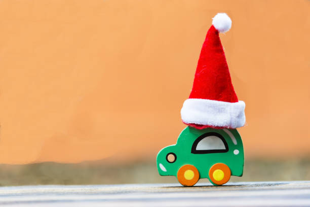 istock Christmas background concept. Toy car with a Santa hat 897012332