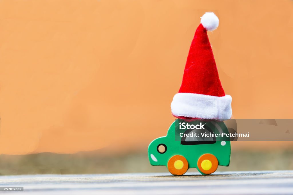 Christmas background concept. Toy car with a Santa hat Bag Stock Photo