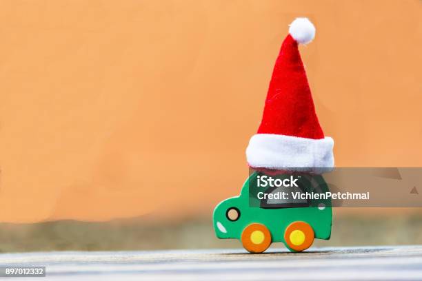 Christmas Background Concept Toy Car With A Santa Hat Stock Photo - Download Image Now