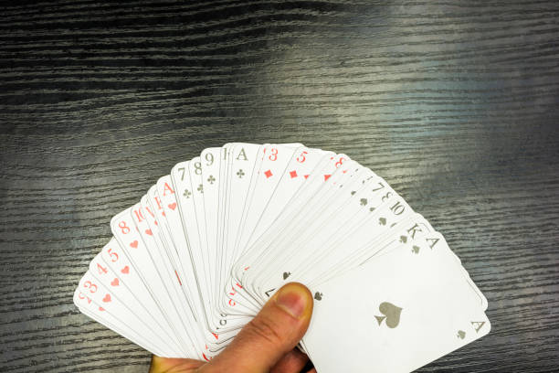 istock Spread deck of playing cards in hand. 897020904
